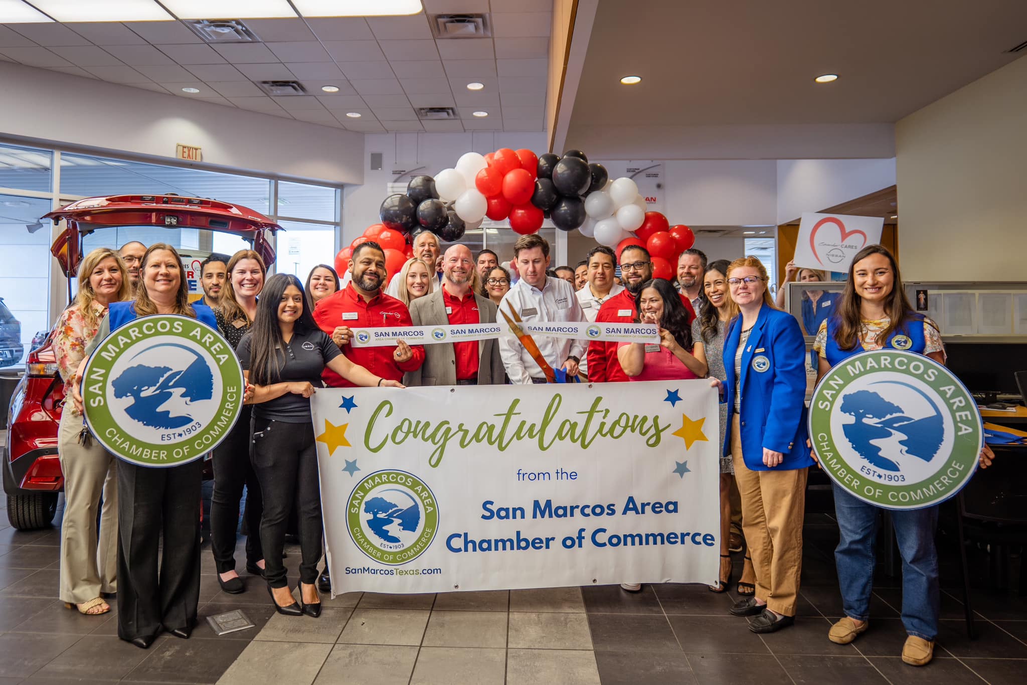 May be an image of 8 people, jeep and text that says 'छा SANMANCOS SAN ANMMICIOS SAN MARCOS MARCOS AREA SAN CHAMBER OF EST#1903 N SAN MARCOS MARCOS SAN ΑΓΕ Congratulations MARCOS .% AT from the 三 San Marcos Area Chamber of Commerce ក្ចបម្ចនា SanMartosTexas.co com AMBER OF ESTA1903 COMMEKCK'