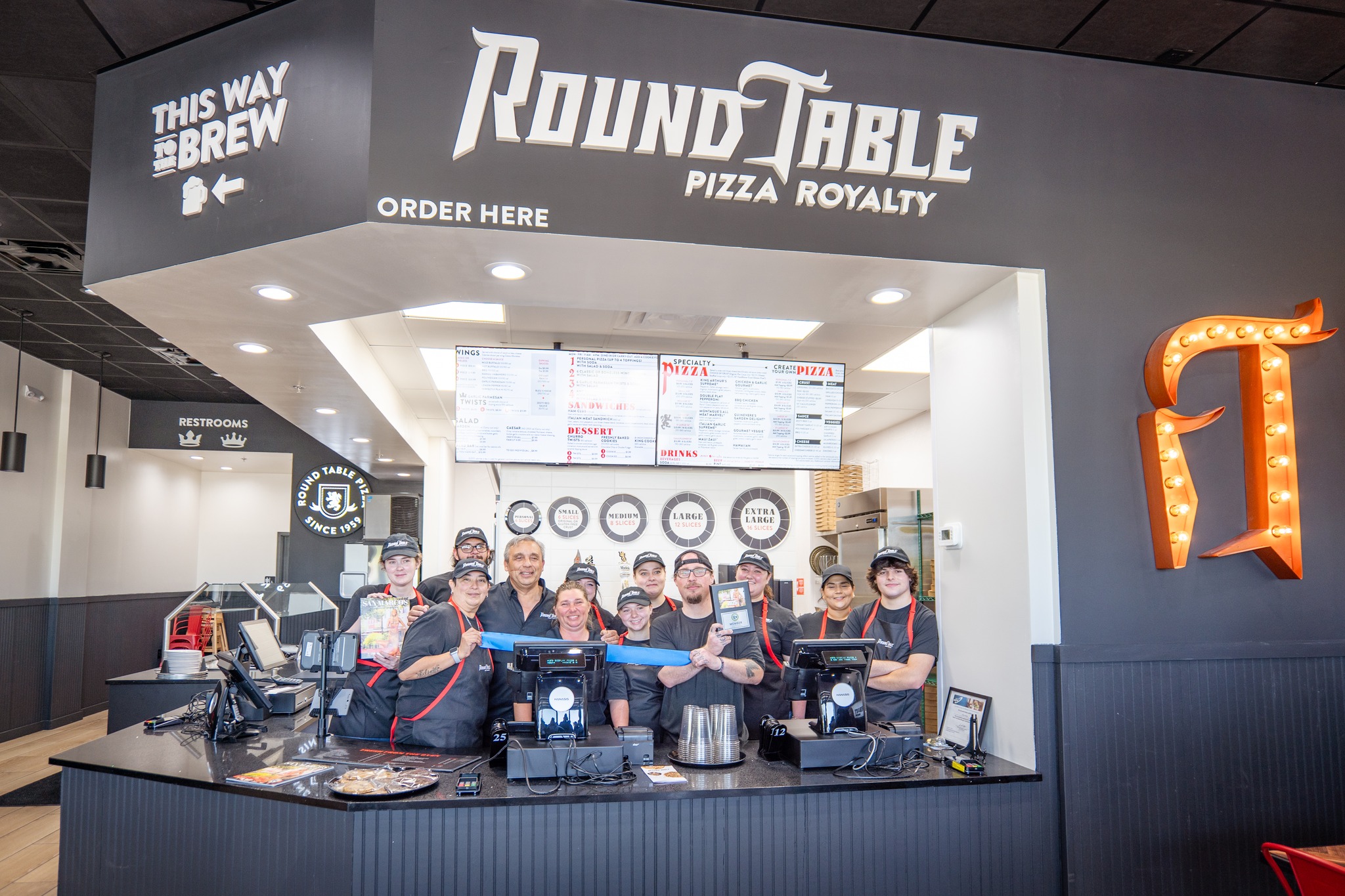 May be an image of 7 people, pizza and text